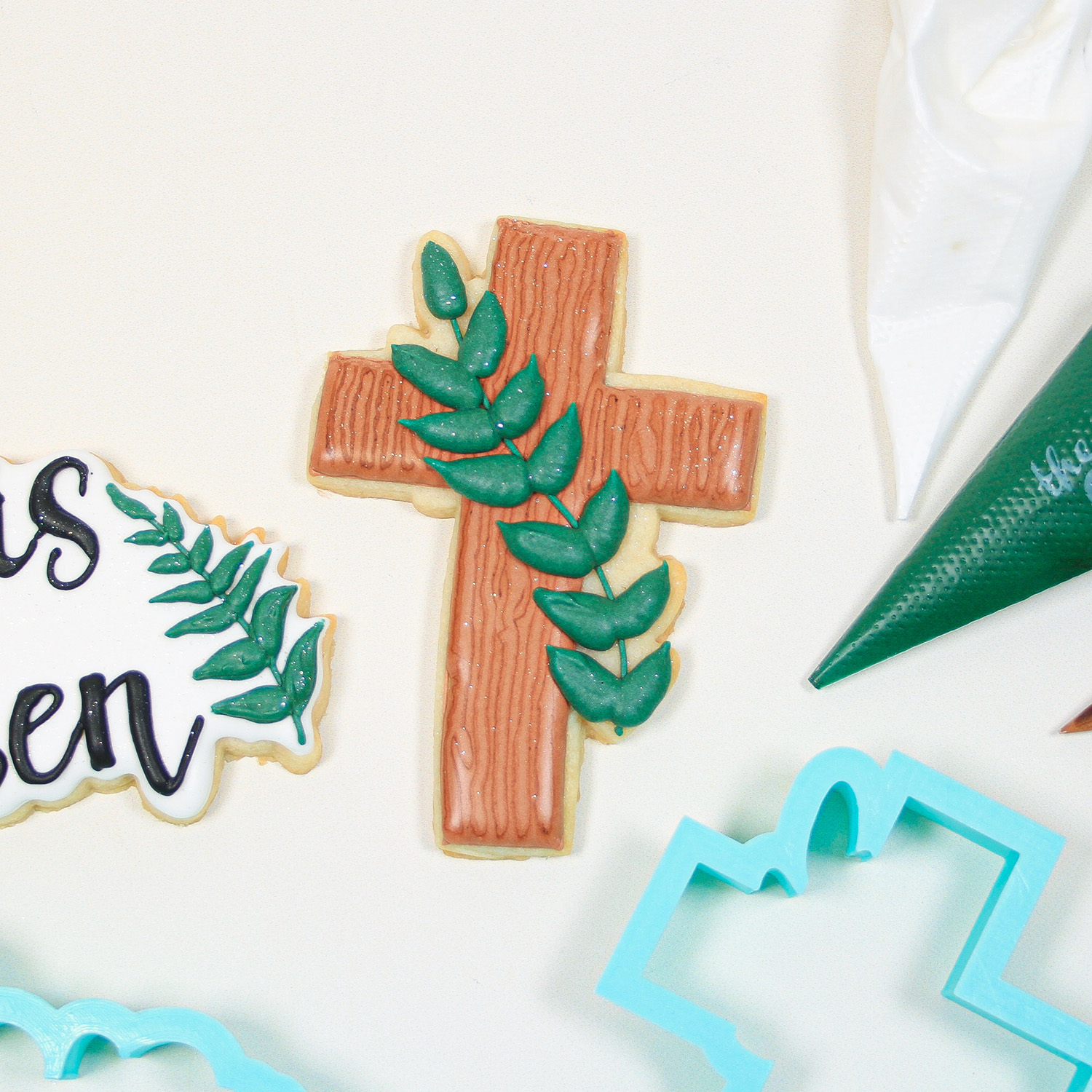 Royal Icing decorated cross cookie features wood grain icing and a green stem with leaves