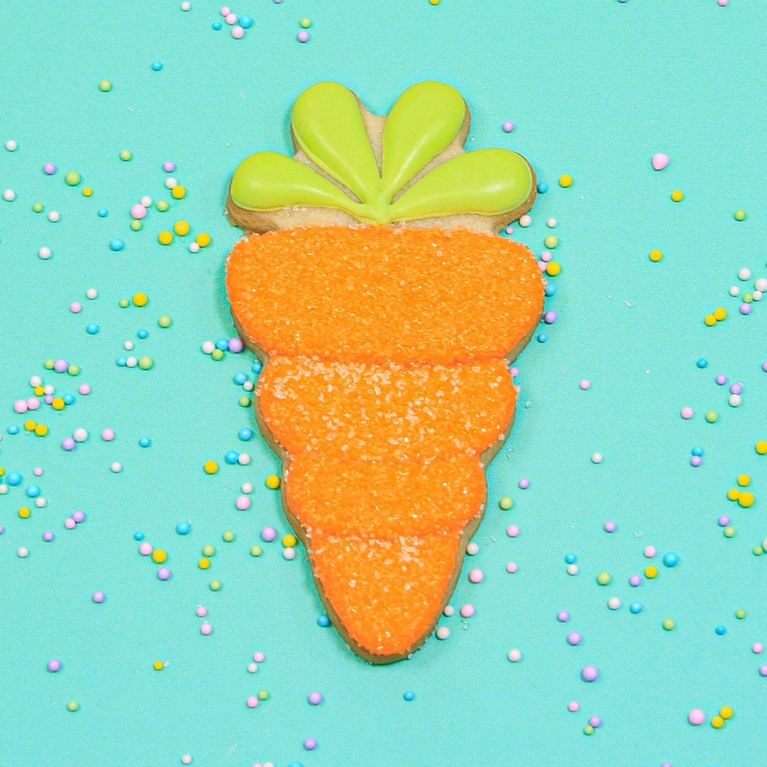 Royal Icing decorated carrot dipped in sanding sugar to sparkle