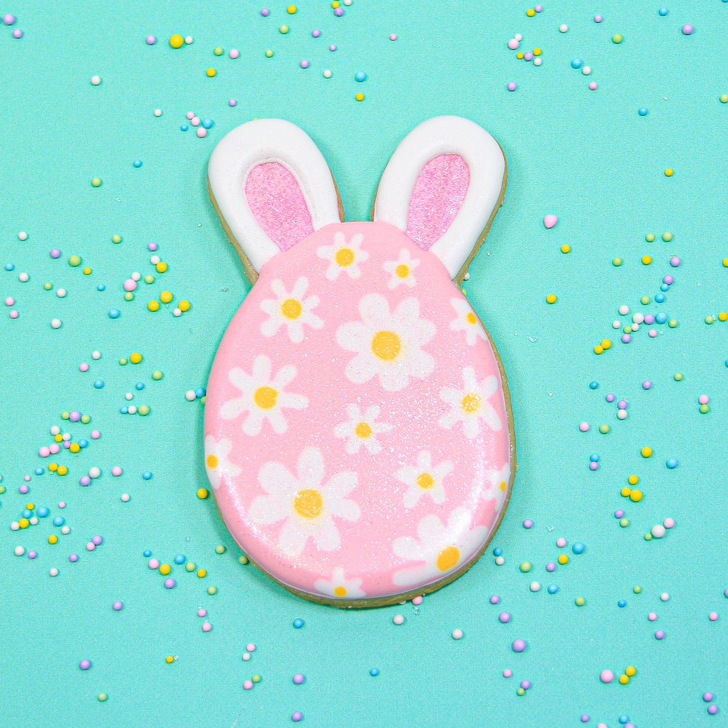 Royal icing decorated easter egg bunny with flowers and sparkles