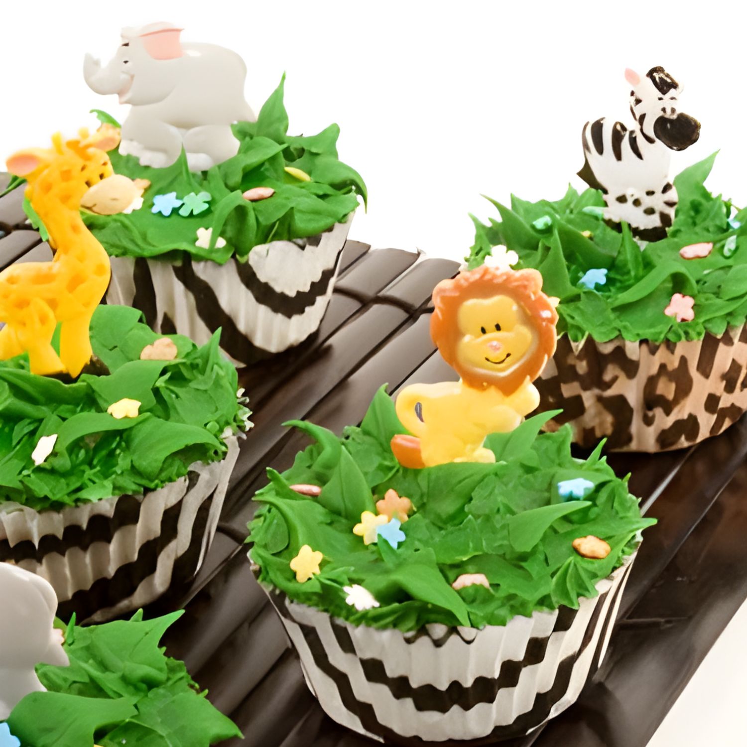 jungle cupcakes with animal print cupcake liners and jungle animal toppers