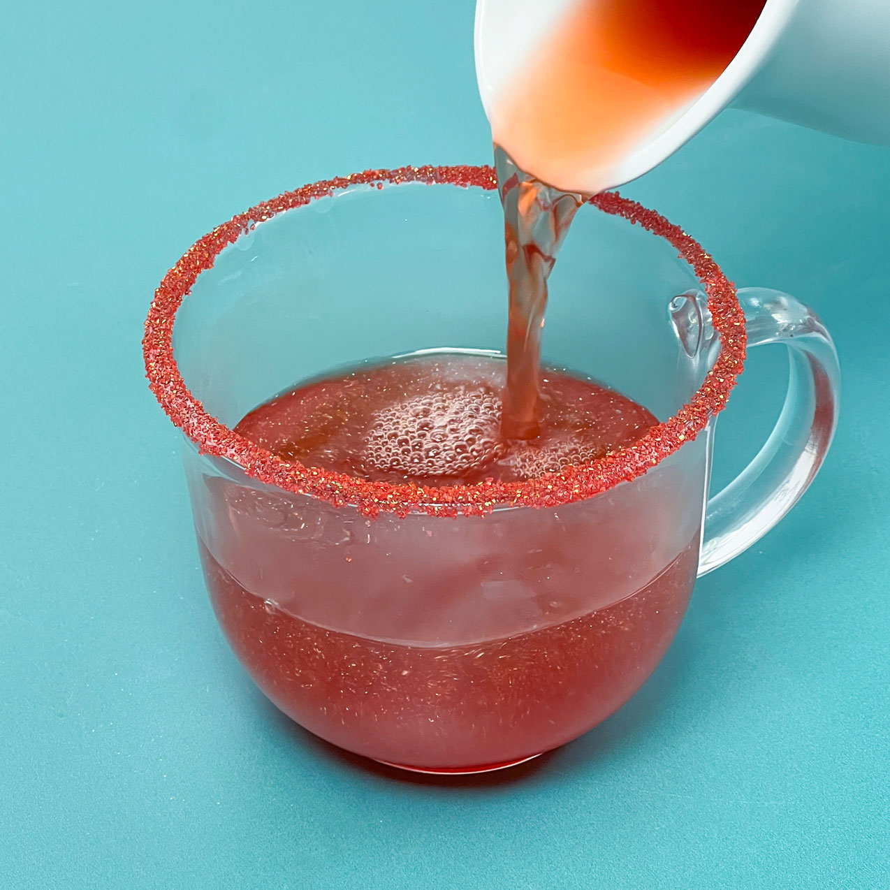 pouring mulled cider into mug