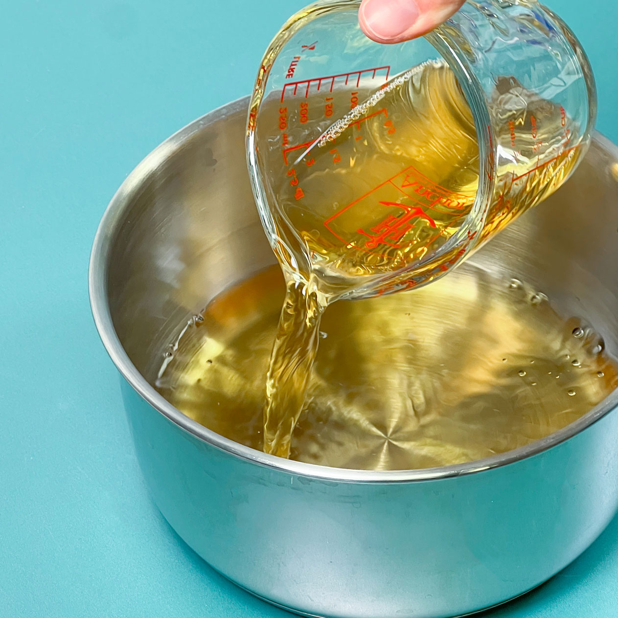 pouring apple juice in saucepot