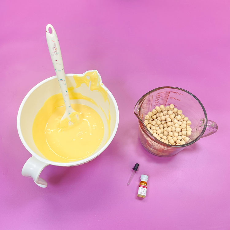 bowl of melted yellow candy melts with banana flavoring and cookie bites