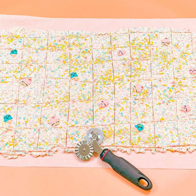 birthday cake bark after being cut into squares with pastry wheel