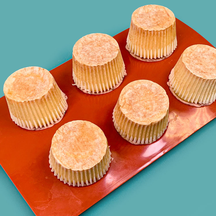 cupcakes pressed into hemisphere mold filled with buttercream and pastry filling