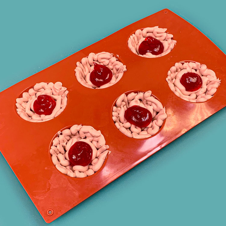 raspberry pastry filling inside of buttercream brain