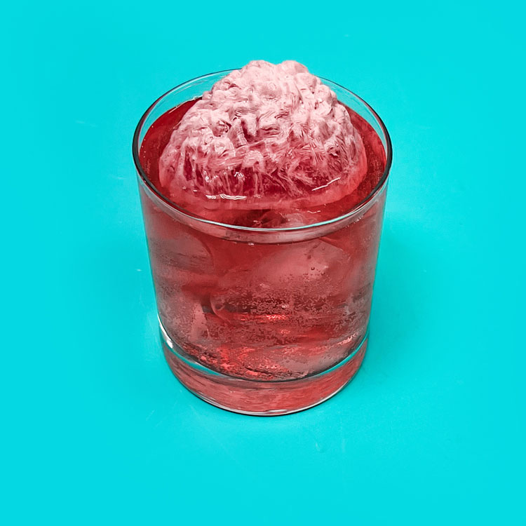 brain ice cube sitting on top of pink drink