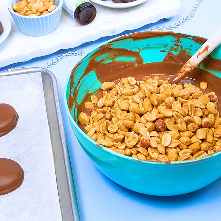 mixing peanuts into melted chocolate