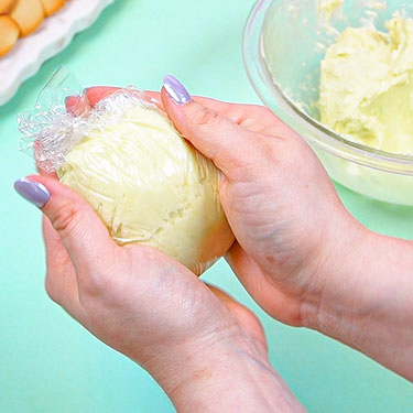 shaping cheeseball mixture in plastic wrap