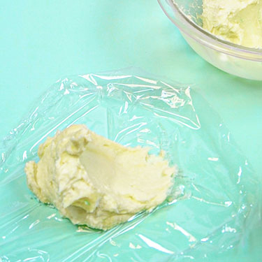 cheeseball mixture on plastic wrap