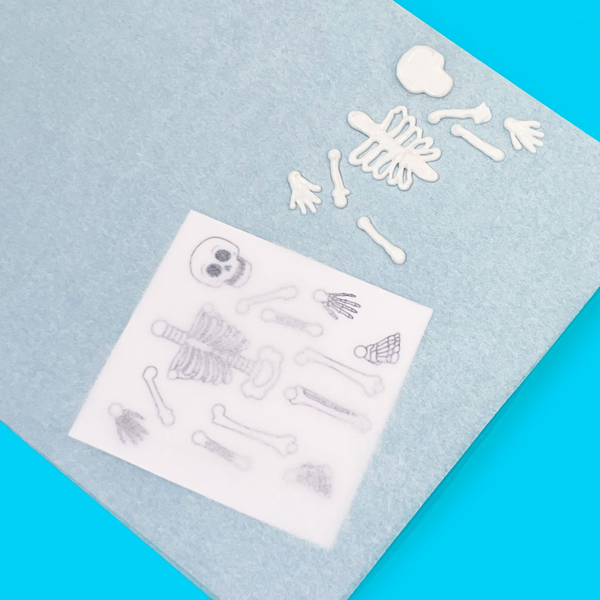 white chocolate skeleton with template under parchment paper