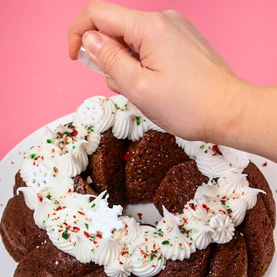 adding edible glitter onto a bundt cake