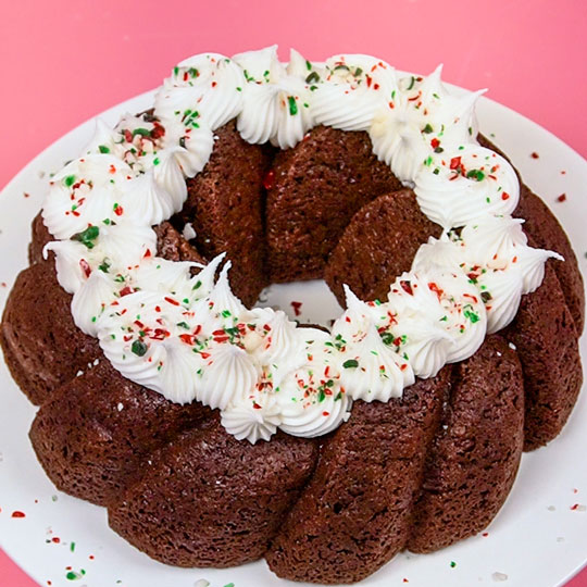 chocolate bundt cake with vanilla buttercream and crushed peppermint
