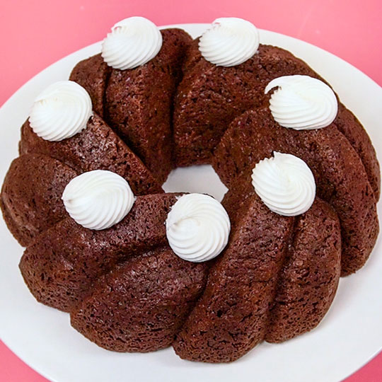 buttercream rosettes on a chocolate bundt cake