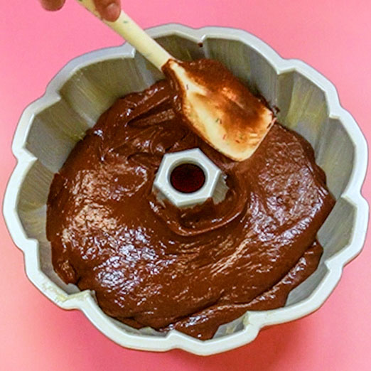 chocolate cake batter in a greased bundt pan