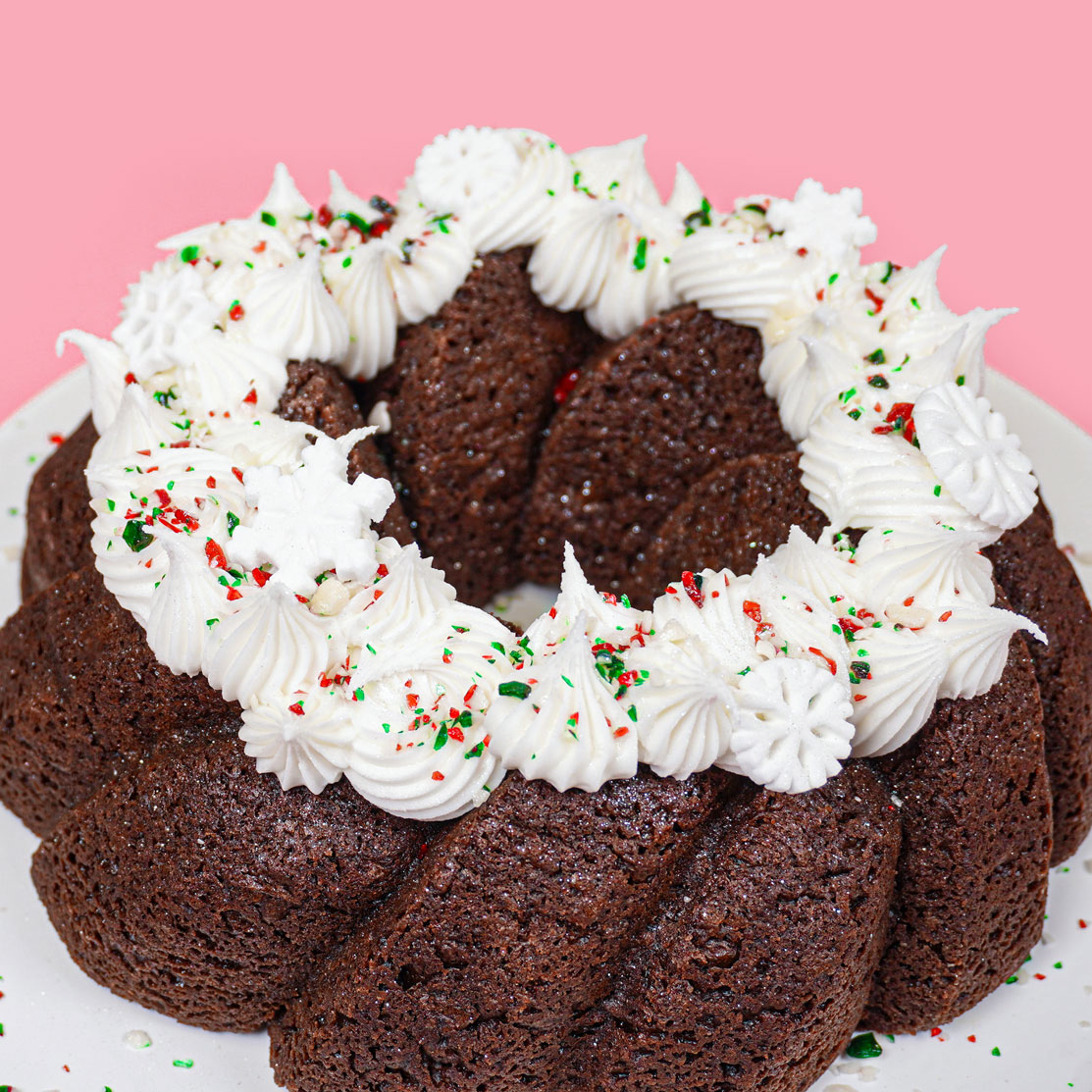 chocolate bundt cake with vanilla buttercream and crushed peppermint and edible glitter