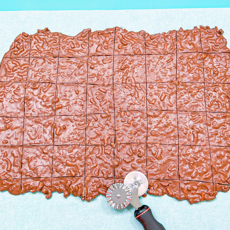 chocolate pretzel bark spread out and scored into squares