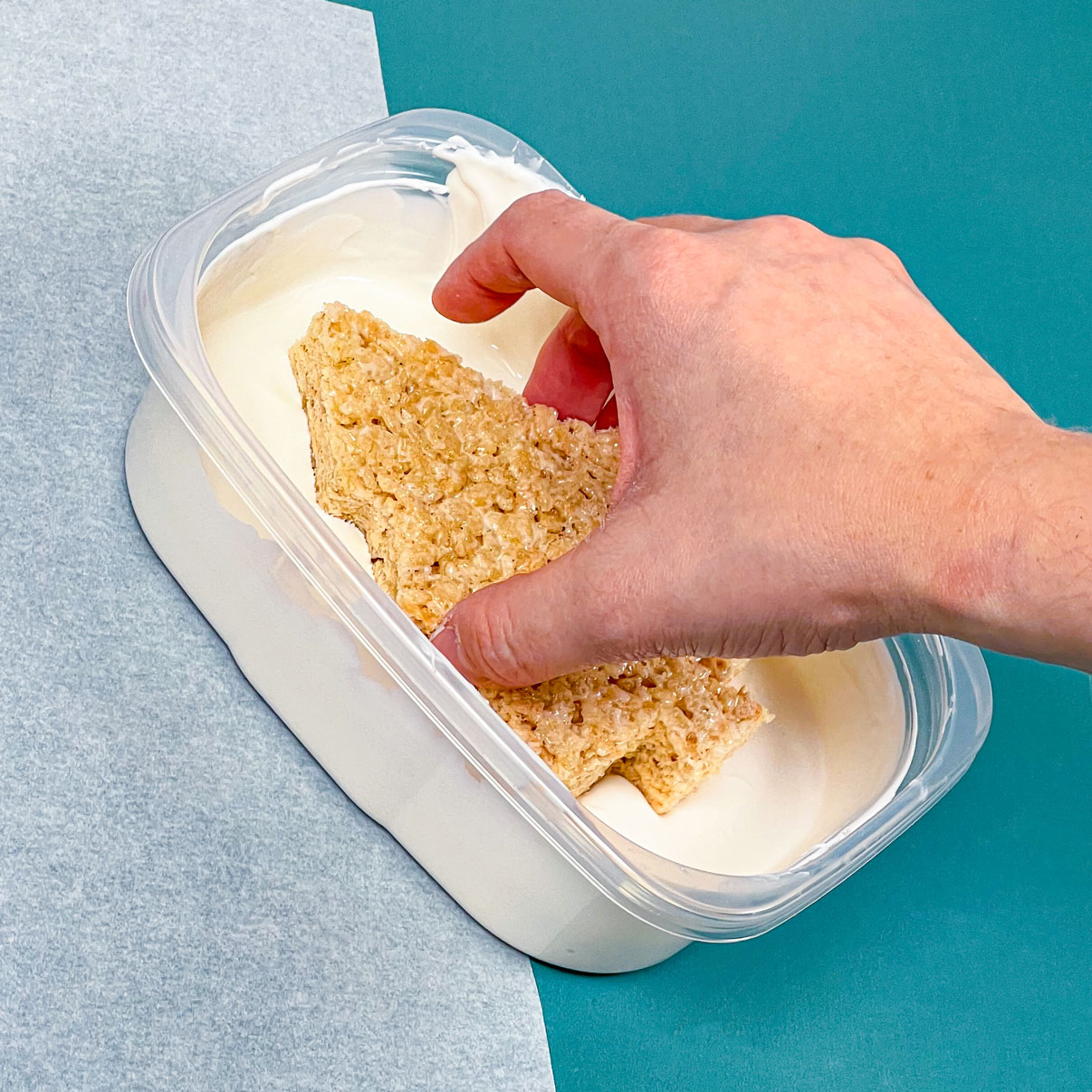dipping rice krispie treat into melted white chocolate />
</div><div class=