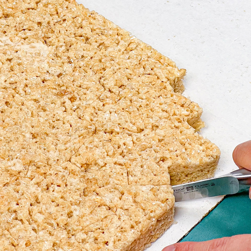 paring knife cutting out rice krispie treat