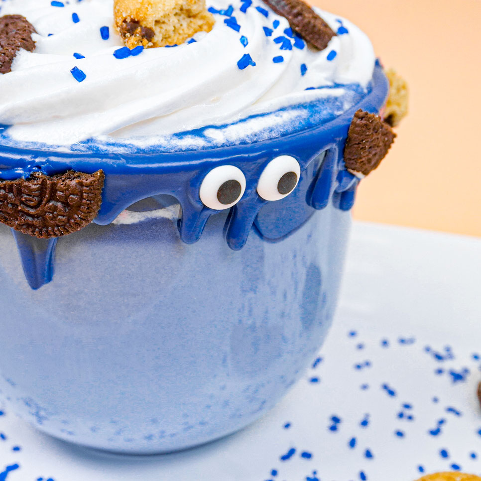 blue hot chocolate with blue chocolate drip and icing eyes