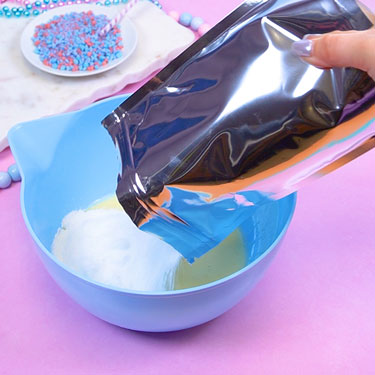 adding dry fondant mix to bowl