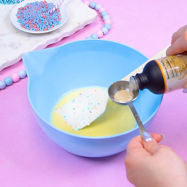 adding cotton candy emulsion into bowl