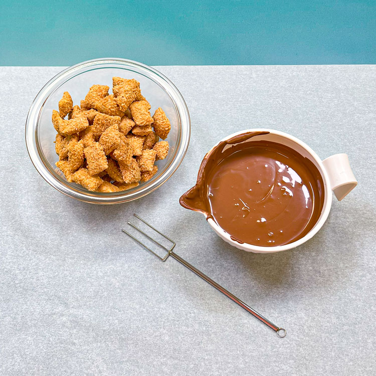 bowl of milk melted chocolate wafers and bowl of peanut butter logs