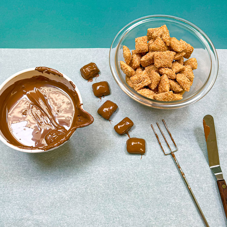 peanut butter logs after dipping into melted chocolate wafers