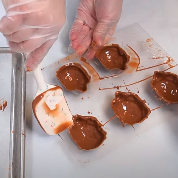 cleaning access chocolate from the turtle-shaped chocolate mold