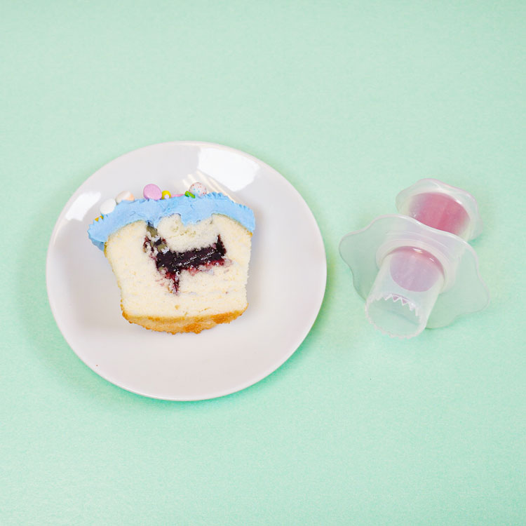 filled cupcake sitting next to cupcake corer