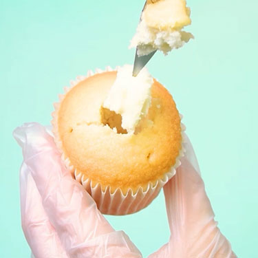 using a paring knife to remove center of vanilla cupcake