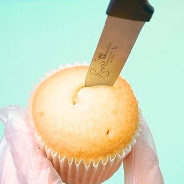 using a paring knife to remove center of vanilla cupcake