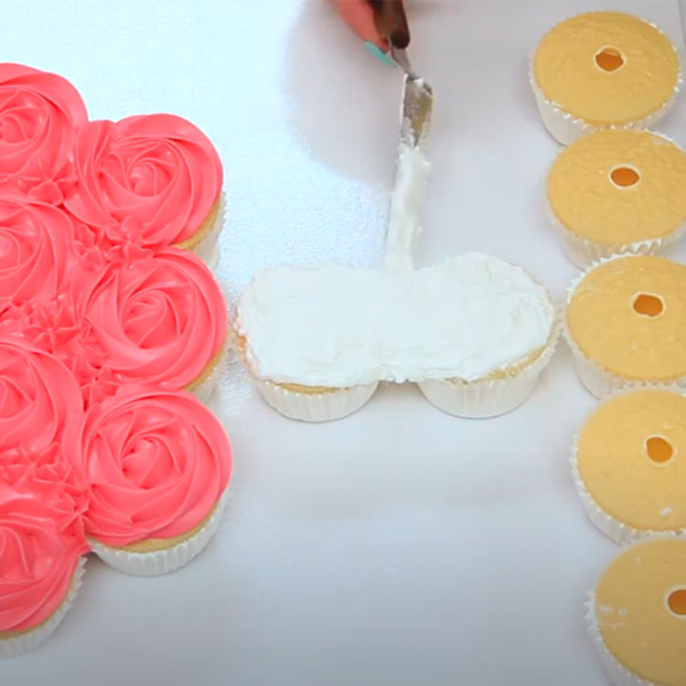 spreading white buttercream with a spatula