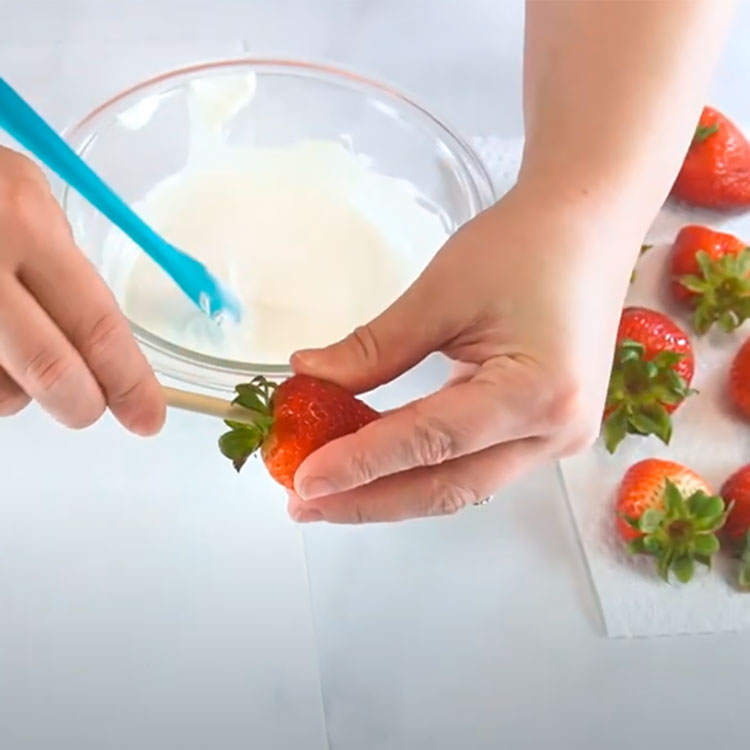 a strawberry with a skewer going through the top