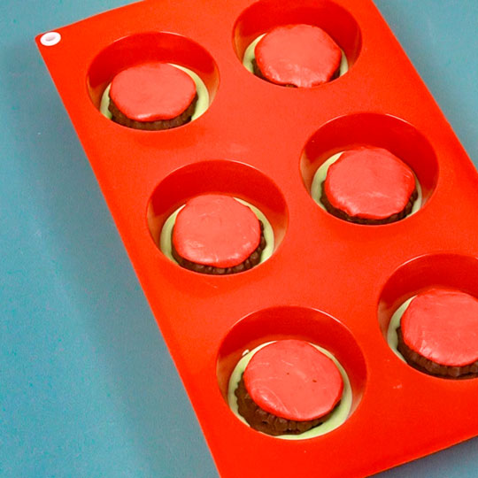 oreo cookies in silicone mold with melted chocolate