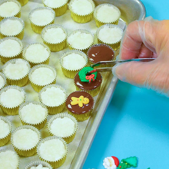 adding christmas decoration on top of layered coconut dessert