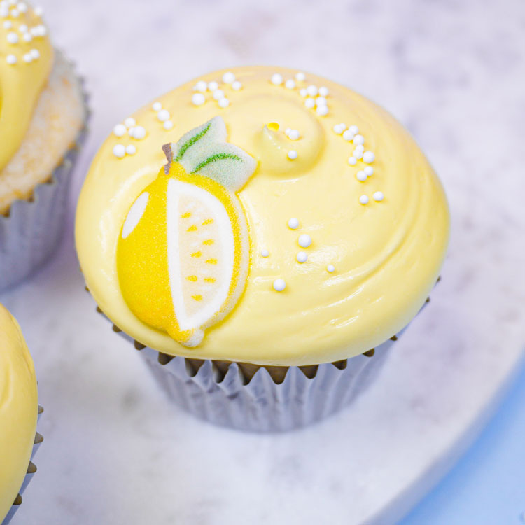 cupcake decorated with lemon frosting and a lemon decoration