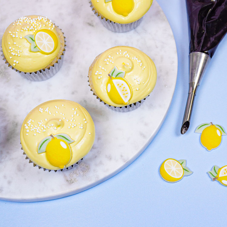 vanilla cupcake frosted with lemon frosting and a lemon sugar decoration