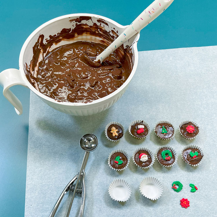 filling candy cups with mint oreo chocolate bark with edible christmas toppers