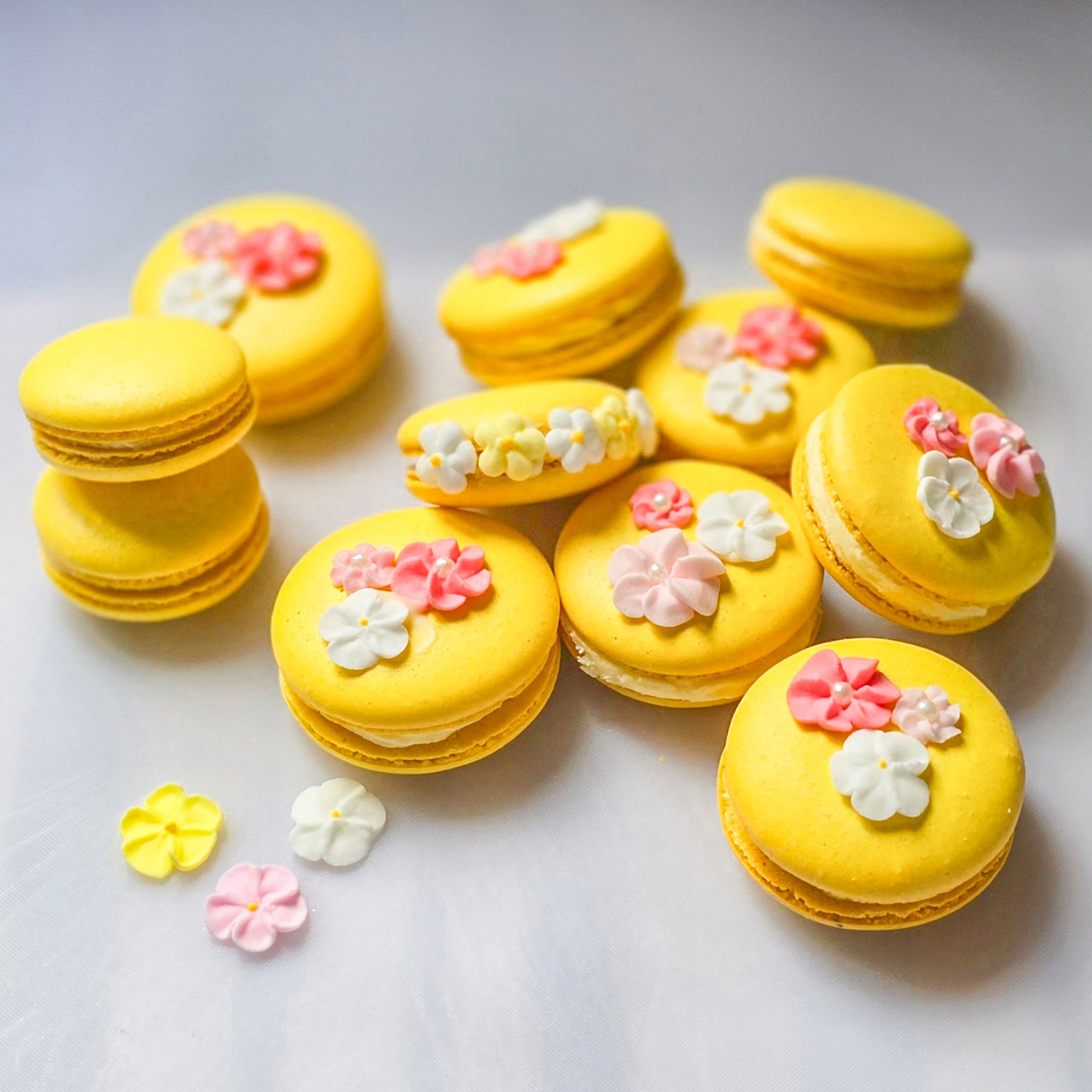 lemon macarons decorated with sugar flowers
