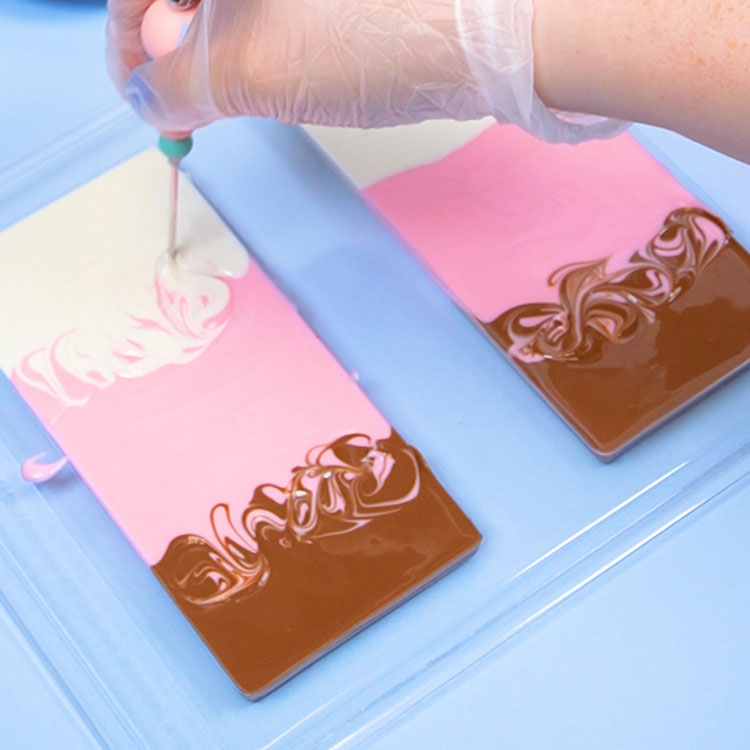 swirling melted chocolate together using a scribe tool
