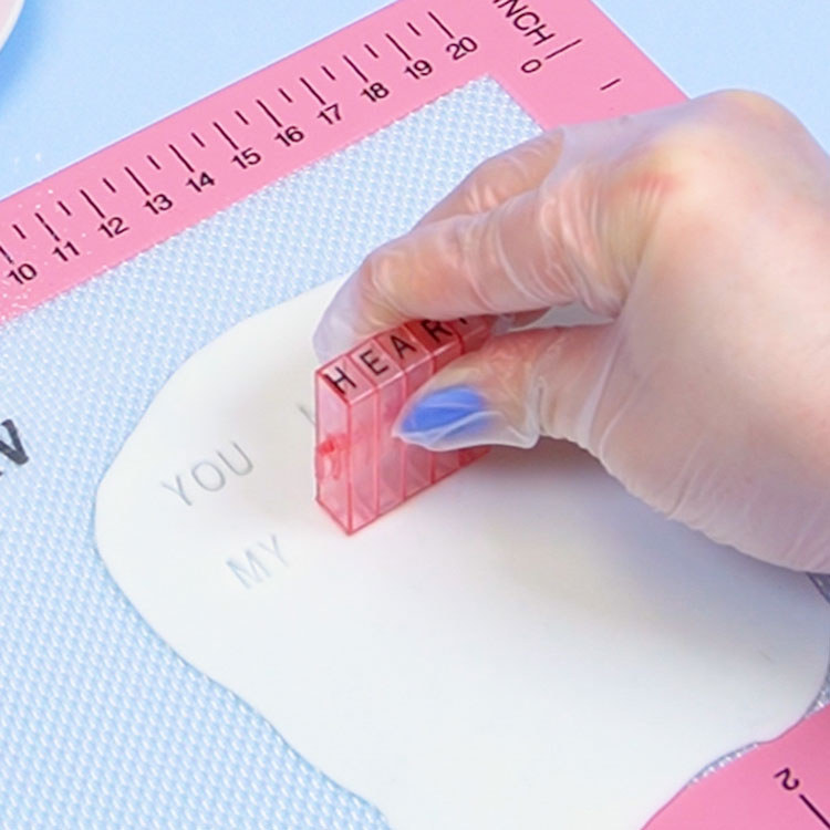 using letter embosser stamps on white fondant