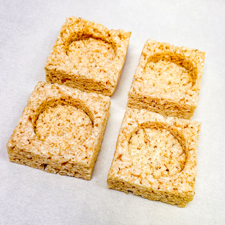 prepared rice krispie treats on a cookie sheet