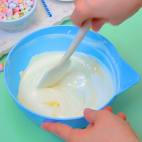 stirring flavoring into melted white chocolate