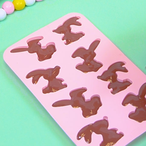 melted brown chocolate in a silicone bunny mold