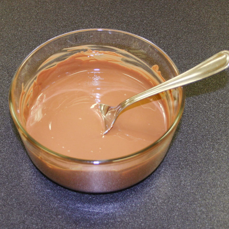 glass bowl of melted chocolate for making peanut butter eggs