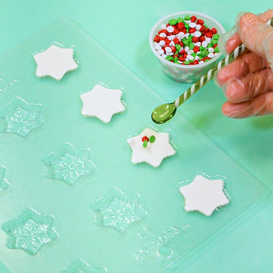 adding christmas chips to chocolate snowflakes
