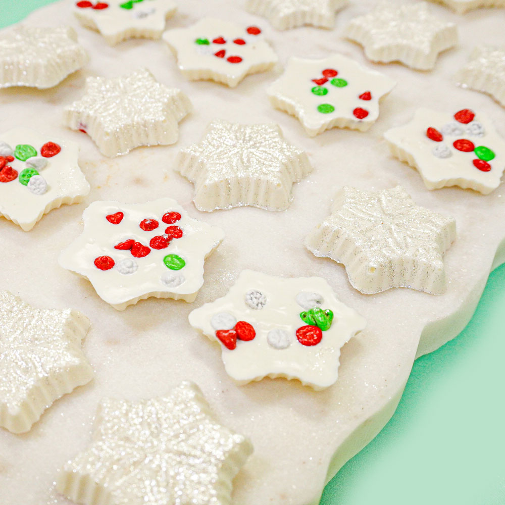 white chocolate snowflake with green red and white chocolate chips and white edible glitter