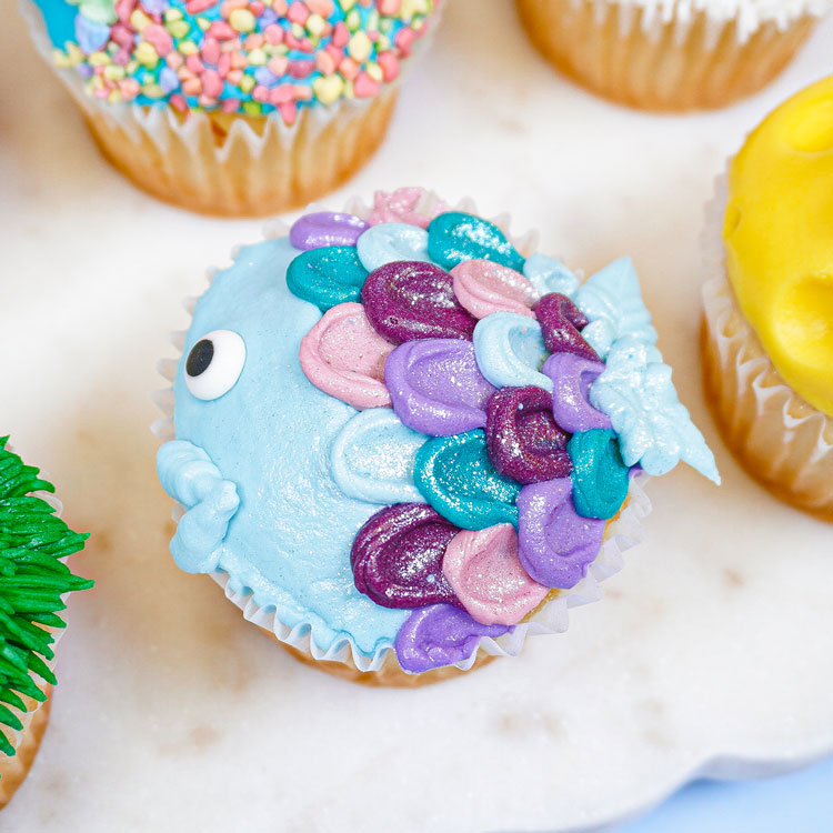 cupcake decorated to look like a rainbow fish