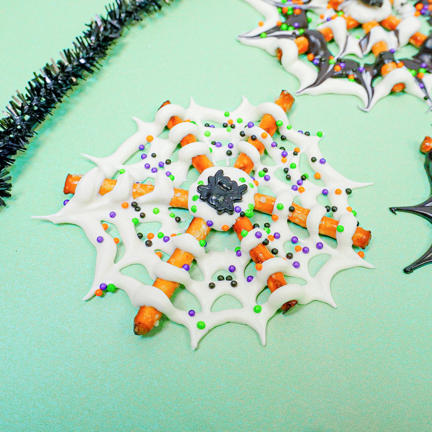white chocolate spider web with sprinkles and candy spider